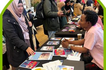 A woman talking to a man at an event.