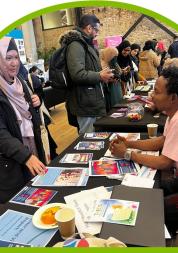 A woman talking to a man at an event.